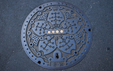 Iron waste drainage cover in Tokyo, Japan.