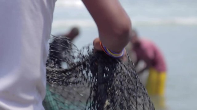 Fishermen with nets on the seashore