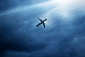 Airplane in dark blue sky and cloud in the strom