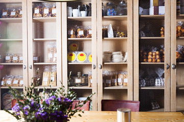 Interior of cafe with sweet stuff in cupboards