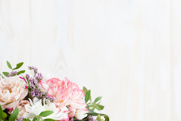 bouquet of flowers on a white wooden background. Copy space