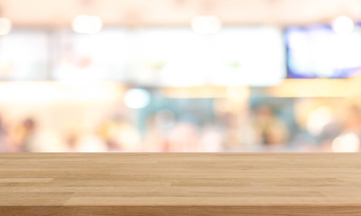 Wood table top and blurred restaurant kitchen interior background - can used for display or montage your products.