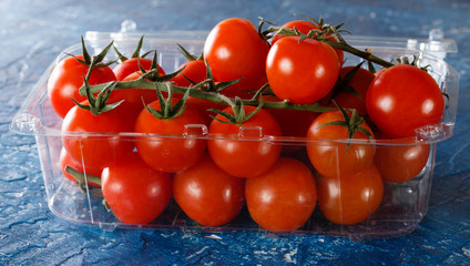 Fresh tomatoes on the vine in plastic