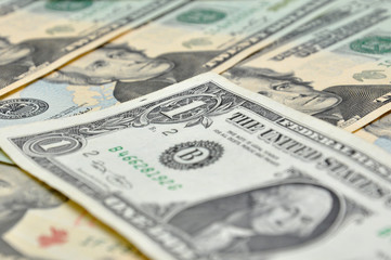 One dollar banknote over the dollars banknotes