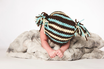 Boy Laying in Big Knitted Blanked