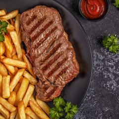 Beef barbecue steak with french fries.