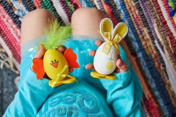Obraz na płótnie Canvas Childhood. Easter eggs in hand.
