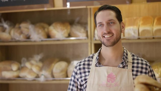  Customer in a bakery shop being served at the counter.