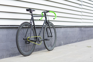 Naklejka na ściany i meble Fixie bike on urban background. Fixed bike.