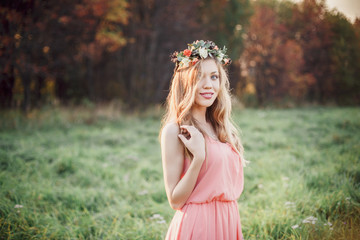 Beautiful bridesmaid in a pink dress looking at the camera.