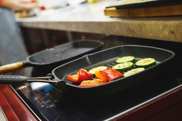 The process of cooking vegetables on the grill. 