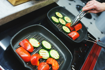 The process of cooking vegetables on the grill. 