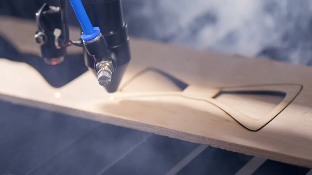 Industrial robotic laser cutter cuts metal parts with great precision