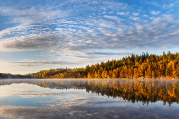 Beautiful Swedish autumn fall landscape with mirrored reflections