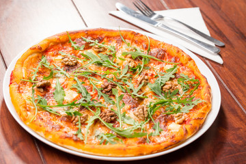 Tasty arugula nuts and blue cheese pizza