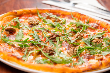 Tasty arugula nuts and blue cheese pizza