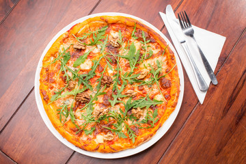 Tasty arugula nuts and blue cheese pizza