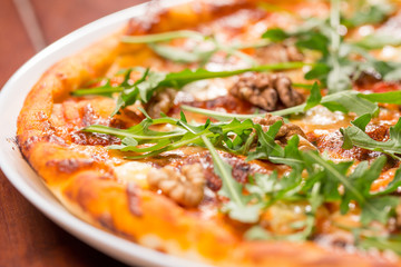 Tasty arugula nuts and blue cheese pizza