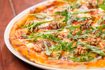 Tasty arugula nuts and blue cheese pizza