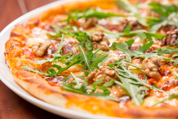 Tasty arugula nuts and blue cheese pizza