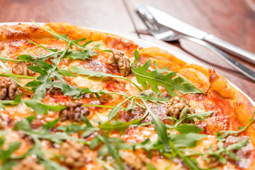 Tasty arugula nuts and blue cheese pizza