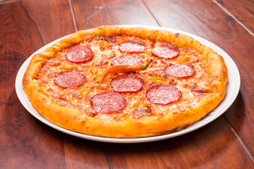 Pizza with hot salami and red pepper