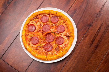 Pizza with hot salami and red pepper
