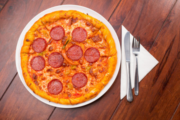 Pizza with hot salami and red pepper