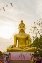 Big Golden Buddha statue over scenic white and blue sky at Wat Sai Dong Yang Temple. Phichit, Thailand.