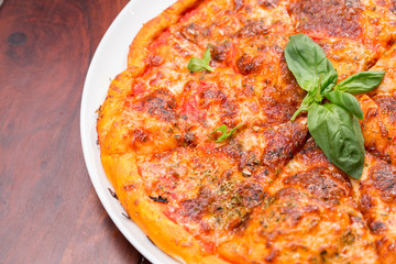 Italian pizza with mozzarella, tomato and basil