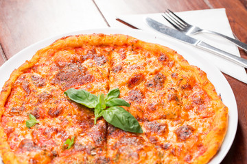 Italian pizza with mozzarella, tomato and basil