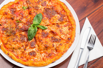 Italian pizza with mozzarella, tomato and basil