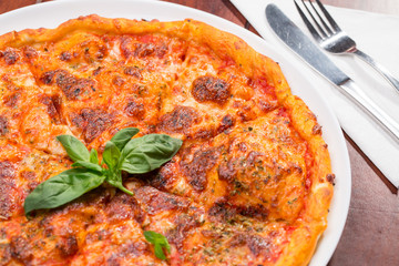 Italian pizza with mozzarella, tomato and basil