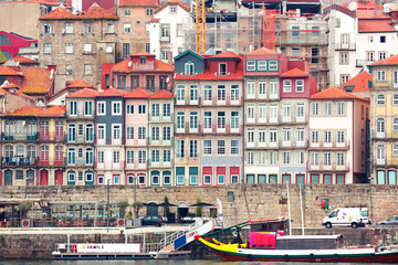 Traditional multicolored quaint houses in Ribeira - the old, vintage and touristic district of Porto and the promenade Douro river, Portugal