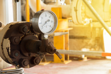 Closeup of pressure gauge , pressure gauge measuring gas pressure. Pipes and valves at oil and gas industrial plant.