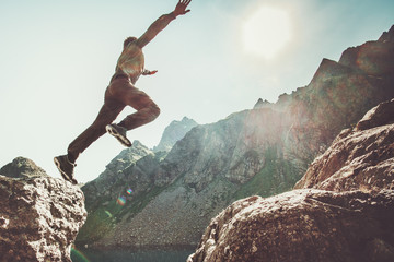 Man jumping to the sun in rocky mountains Travel Lifestyle happiness and success motivation concept adventure summer vacations outdoor mountaineering sport