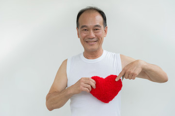old man on whit shirt holding a red heart on white background