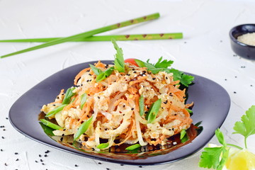 Korean traditional food. Raw chicken marinated with vegetables on a black plate on a white abstract background. easy cooking. Healthy food.