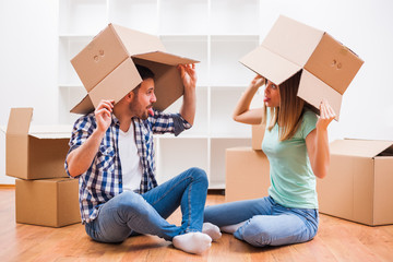 
Young couple is moving in their new home. It's time for unpacking.