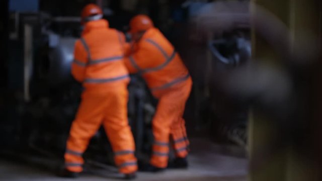  Engineers in power station carrying out maintenance & checking the machinery