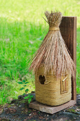 Nesting box from straw on a tree stub