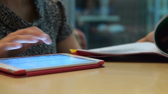 Businesswoman in cafe working with documents and using digital tablet. Doing job outside the office