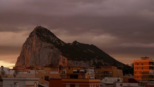 Dramatic morning sky above the Rock of Gibraltar and La Linea de la Concepcion cityscape in Spain.