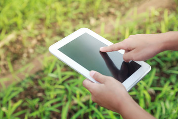 Asian student holding her tablet.
