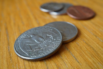 Set of silver Quarter Dollar coins (currency in the USA, American Dollar, USD) on the wooden...