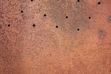 rusty sheet of iron with holes