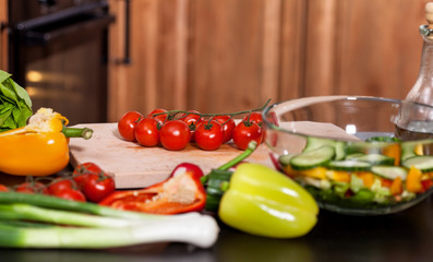 Making a fresh vegetables salad - adding the tomatos