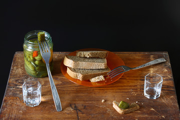 Feast for two. Vodka, black bread, salted cucumber on a wooden background. Binge and  appetizer in Russian style. - 143416446