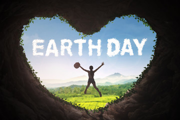 Woman in cave with Earth Day text