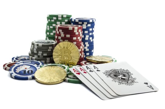 Bitcoin coins with poker cards and chips